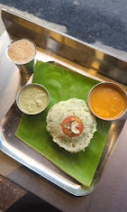 Rice bath served on a banana leaf with chutney and sambar